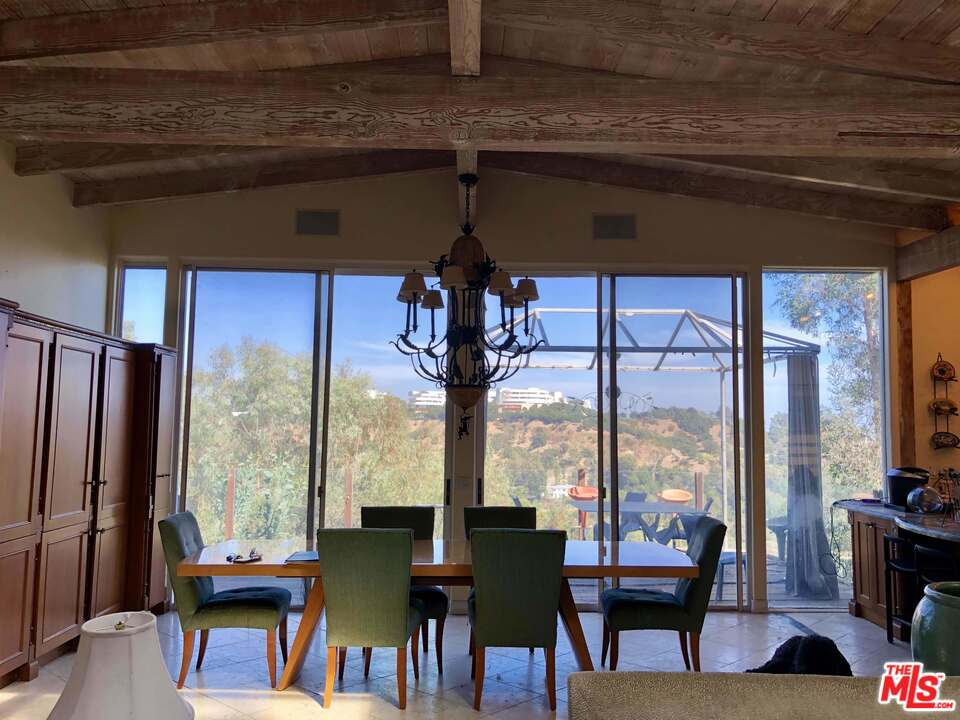 960 North Tigertail Road Los Angeles, CA 90049 - Photo 5 of 13 a view of a dining room with furniture window and outside view