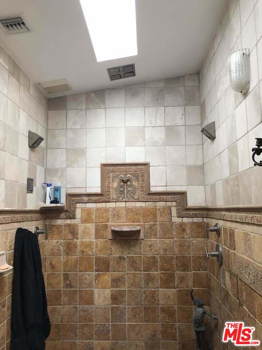 960 North Tigertail Road Los Angeles, CA 90049 - Photo 9 of 13 a bathroom with a sink and a shower