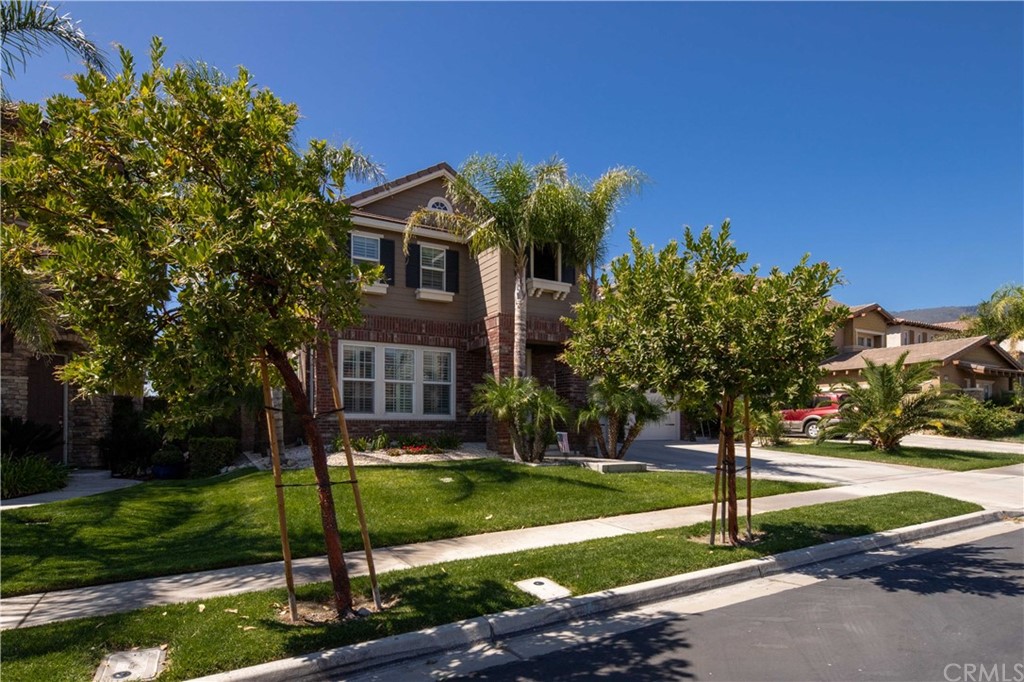 5448 Turin Way Fontana, CA 92336 - Photo 1 of 1 a front view of a house with a yard