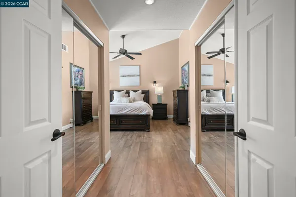 a bedroom with a bed and a view of living room