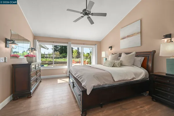 a large bed sitting in a bedroom next to a window