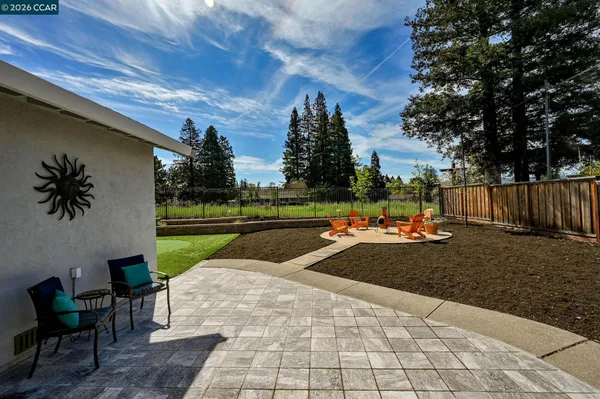 a view of yard with swimming pool and sitting area