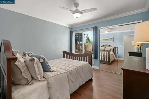 a bedroom with bed and a large window