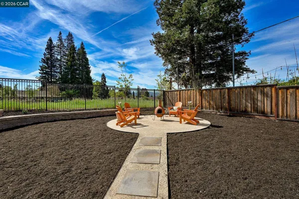 a view of a backyard with sitting area