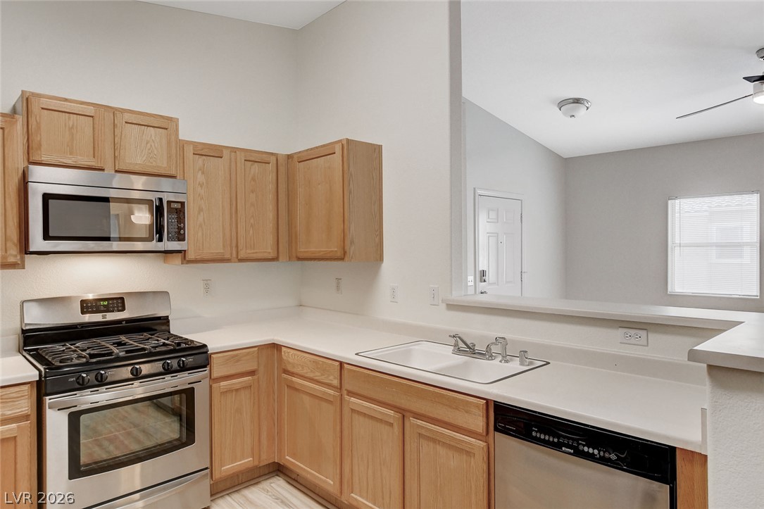 2052 Quarry Ridge Street, Unit 201 Las Vegas, NV 89117 - Photo 10 of 25 A well-appointed kitchen features a gas range and built-in microwave for culinary convenience.