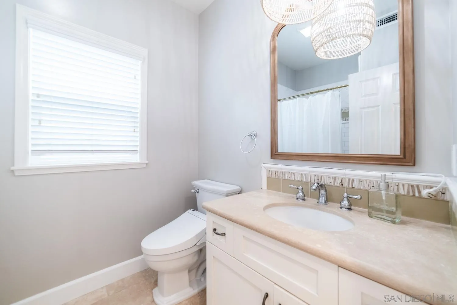 742 Cornish Drive Encinitas, CA 92024 - Photo 22 of 30 a bathroom with a granite countertop toilet sink and mirror