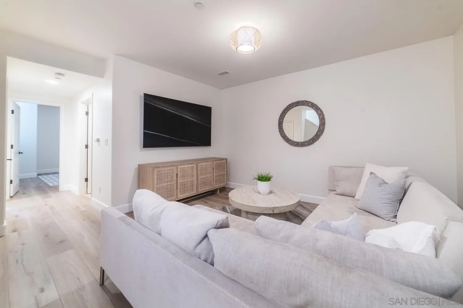 742 Cornish Drive Encinitas, CA 92024 - Photo 23 of 30 a living room with furniture and a flat screen tv