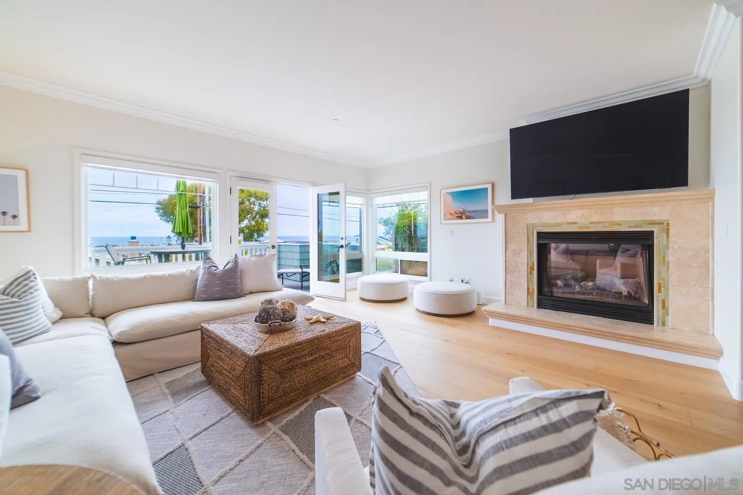 742 Cornish Drive Encinitas, CA 92024 - Photo 4 of 30 a living room with furniture a flat screen tv and a fireplace