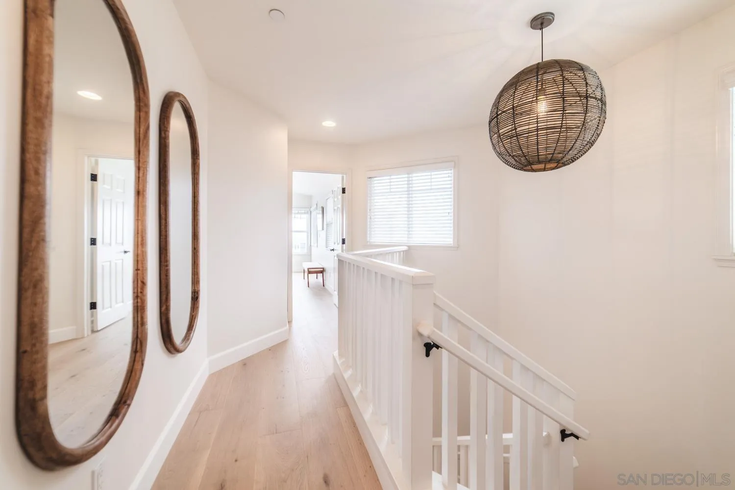 742 Cornish Drive Encinitas, CA 92024 - Photo 10 of 30 a view of a room with wooden floor and white walls