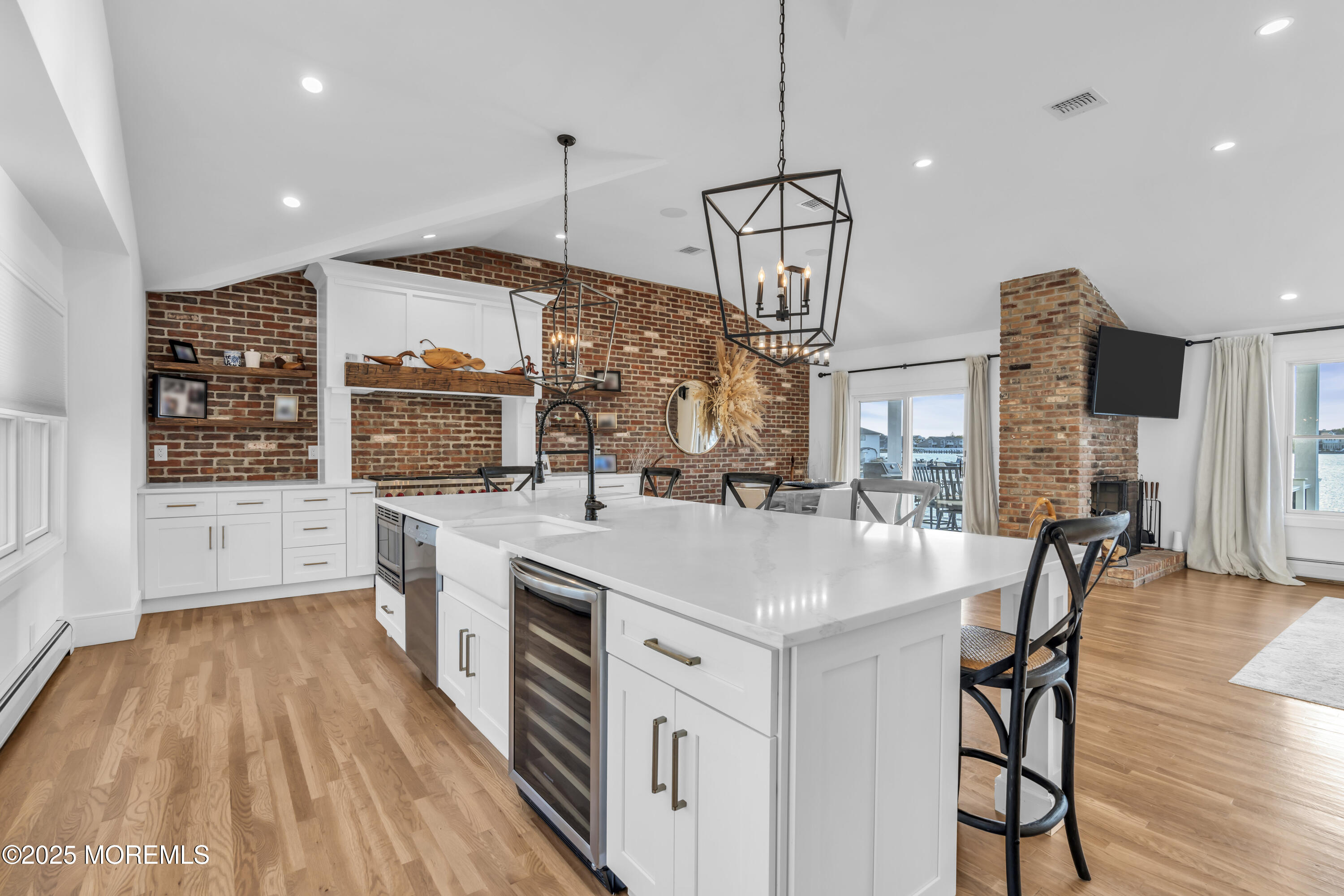 8 Channel Road Toms River, NJ 08753 - Photo 16 of 60 a open kitchen with stainless steel appliances granite countertop a stove and chairs with wooden floors