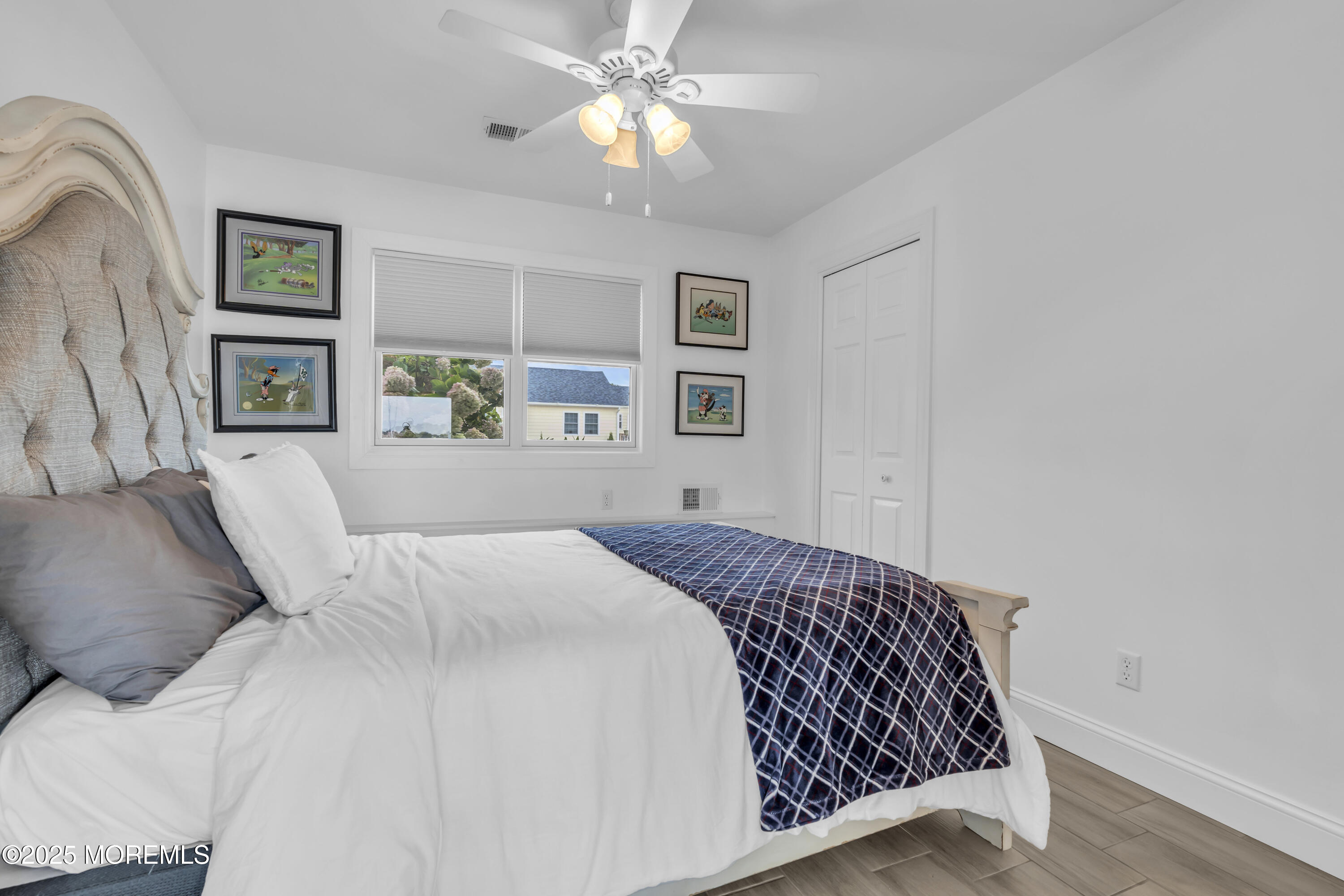 8 Channel Road Toms River, NJ 08753 - Photo 29 of 60 a bedroom with a large bed and a chandelier