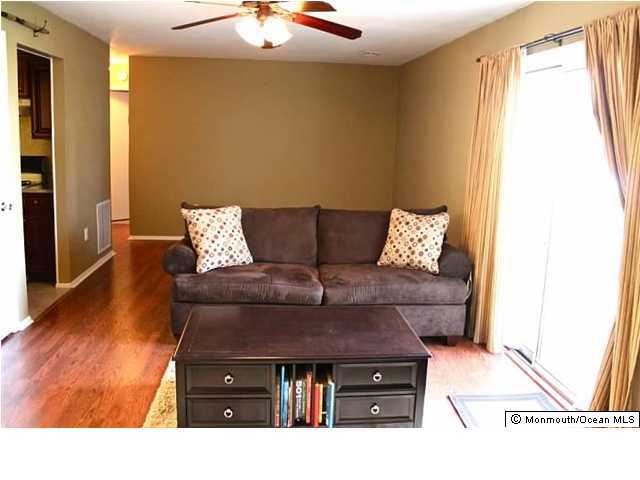 1606 Main Street, Unit R100 Lake Como, NJ 07719 - Photo 2 of 3 a living room with furniture and wooden floor