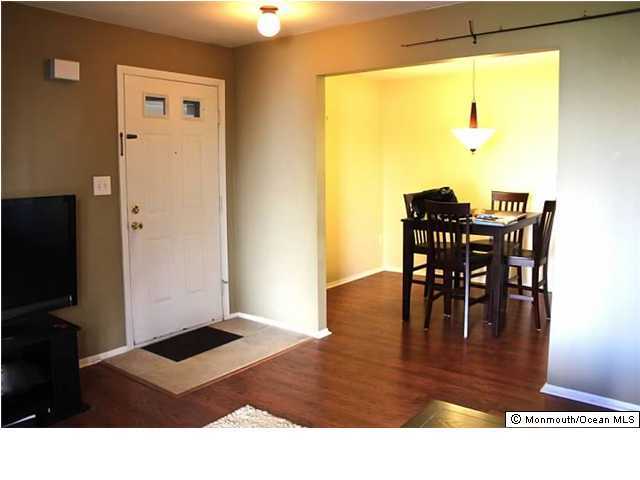 1606 Main Street, Unit R100 Lake Como, NJ 07719 - Photo 3 of 3 a living room with dining table and a large window