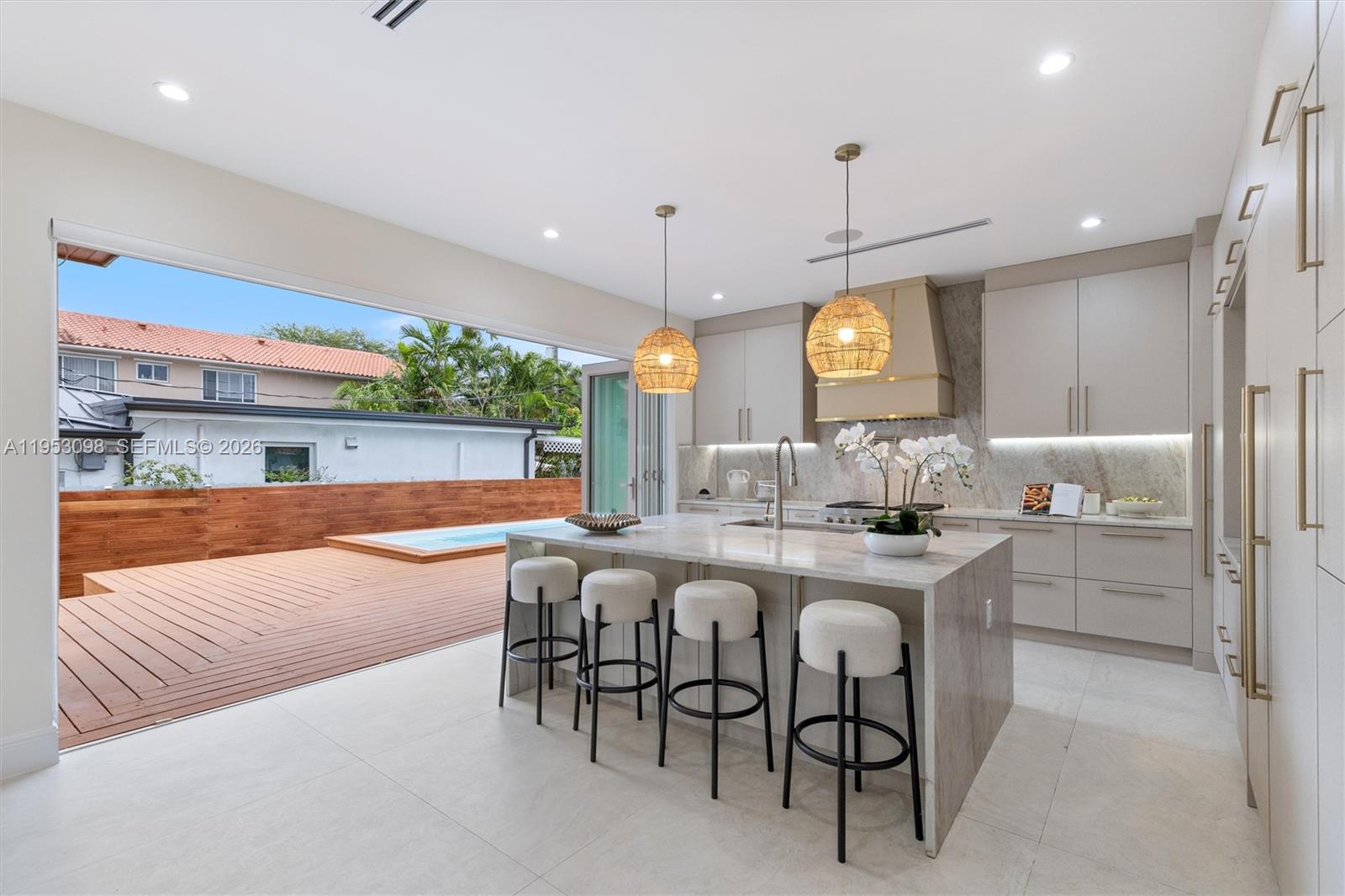 3495 Southwest 3rd Avenue Miami, FL 33145 - Photo 12 of 35 a large kitchen with a table and chairs
