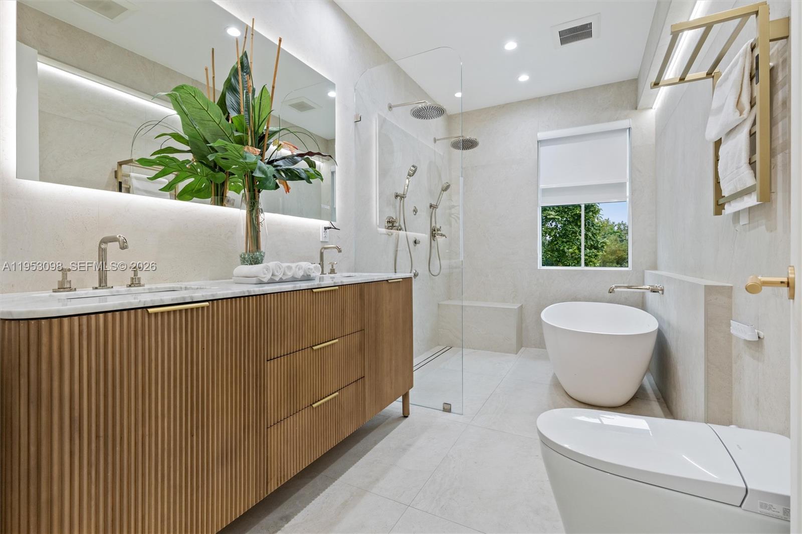 3495 Southwest 3rd Avenue Miami, FL 33145 - Photo 19 of 35 a bathroom with a granite countertop sink a toilet and mirror