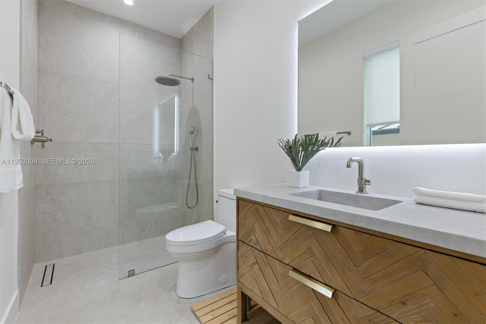 3495 Southwest 3rd Avenue Miami, FL 33145 - Photo 20 of 35 a bathroom with a granite countertop sink a toilet and shower