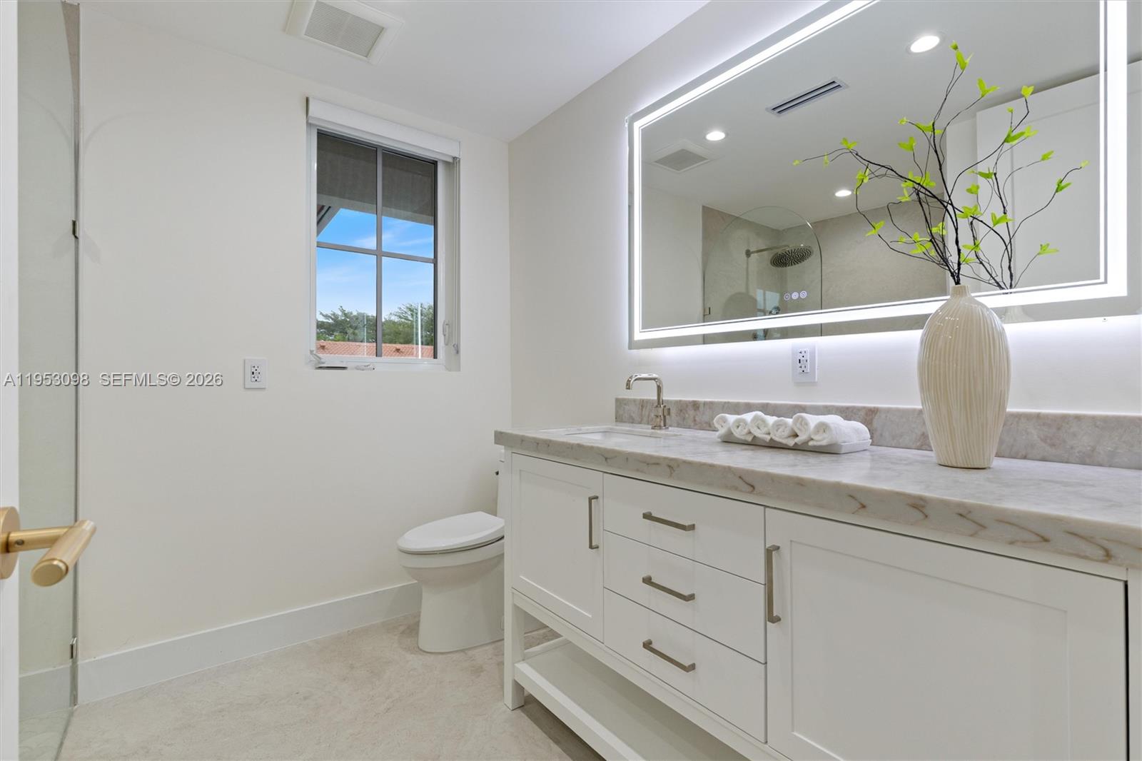 3495 Southwest 3rd Avenue Miami, FL 33145 - Photo 22 of 35 a bathroom with a granite countertop toilet sink and mirror