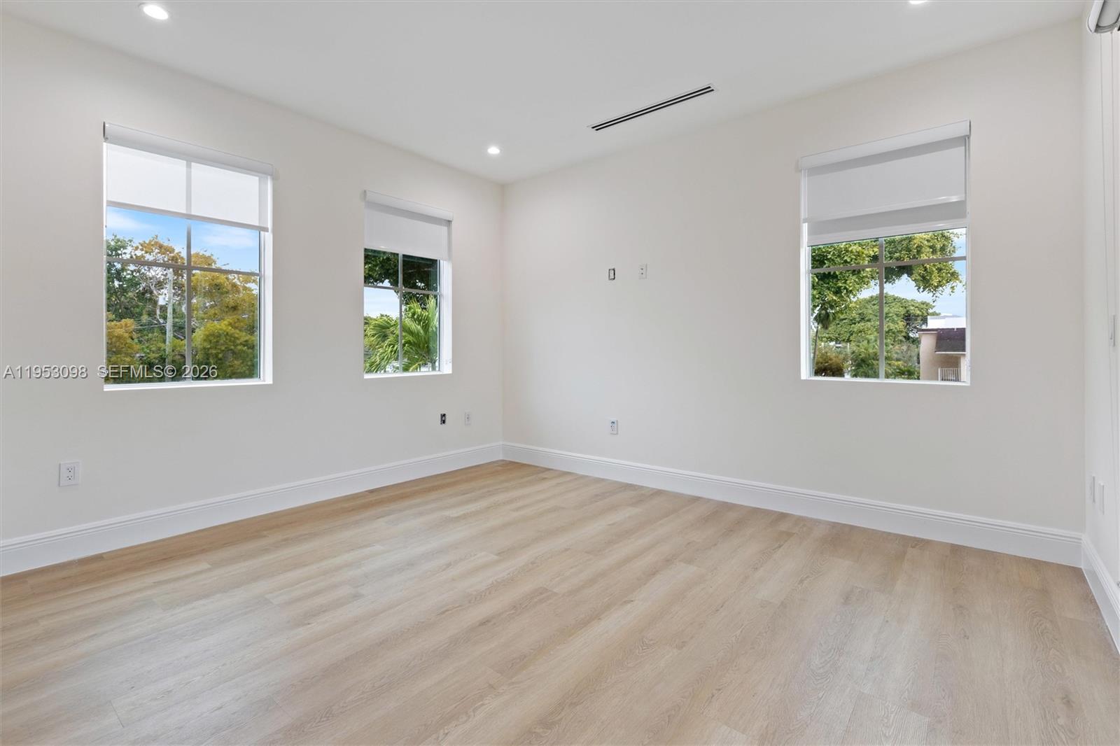 3495 Southwest 3rd Avenue Miami, FL 33145 - Photo 23 of 35 a view of an empty room with wooden floor and a window
