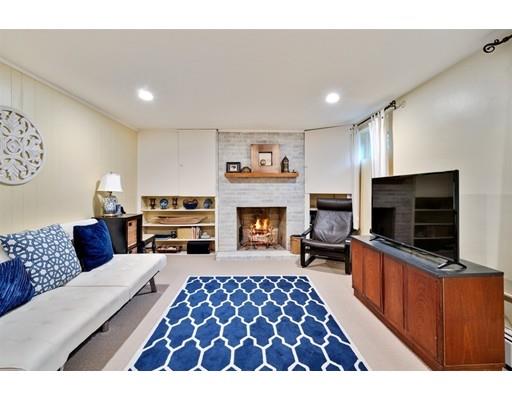 11 Glover Road Needham, MA 02494 - Photo 16 of 24 a living room with furniture flat screen tv and a fireplace