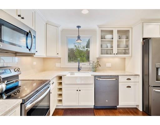 11 Glover Road Needham, MA 02494 - Photo 3 of 24 a kitchen with stainless steel appliances granite countertop a sink stove and microwave