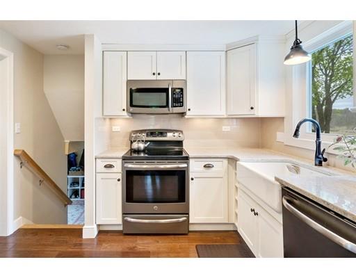 11 Glover Road Needham, MA 02494 - Photo 4 of 24 a kitchen with stainless steel appliances granite countertop a stove a sink and a microwave