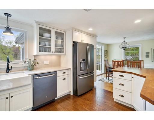 11 Glover Road Needham, MA 02494 - Photo 5 of 24 a kitchen with cabinets wooden floor and stainless steel appliances