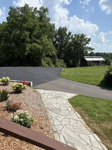 a backyard of a house with table and chairs