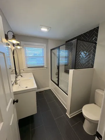 a bathroom with a toilet and a shower