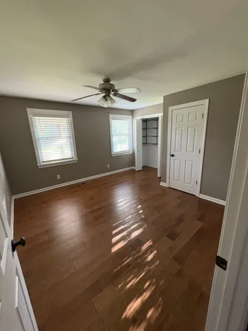 a view of wooden floor and windows in an empty room