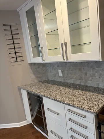 a kitchen with a sink a stove and cabinets