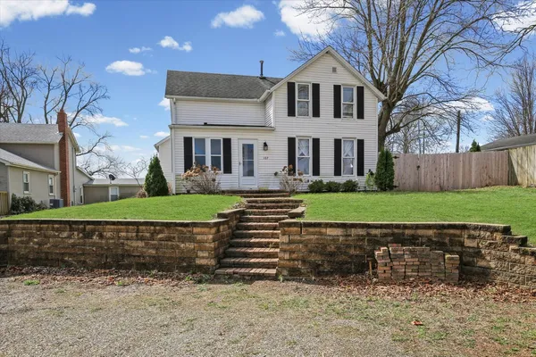 a front view of a house with a yard