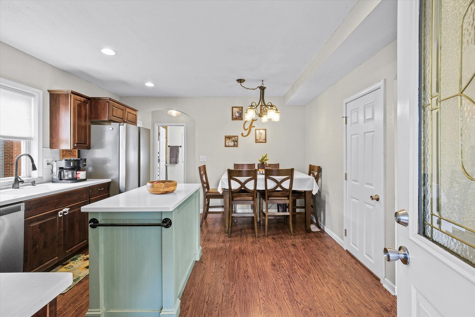 107 Washington Street Congerville, IL 61729 - Photo 11 of 39 a kitchen with stainless steel appliances a dining table chairs and wooden floor