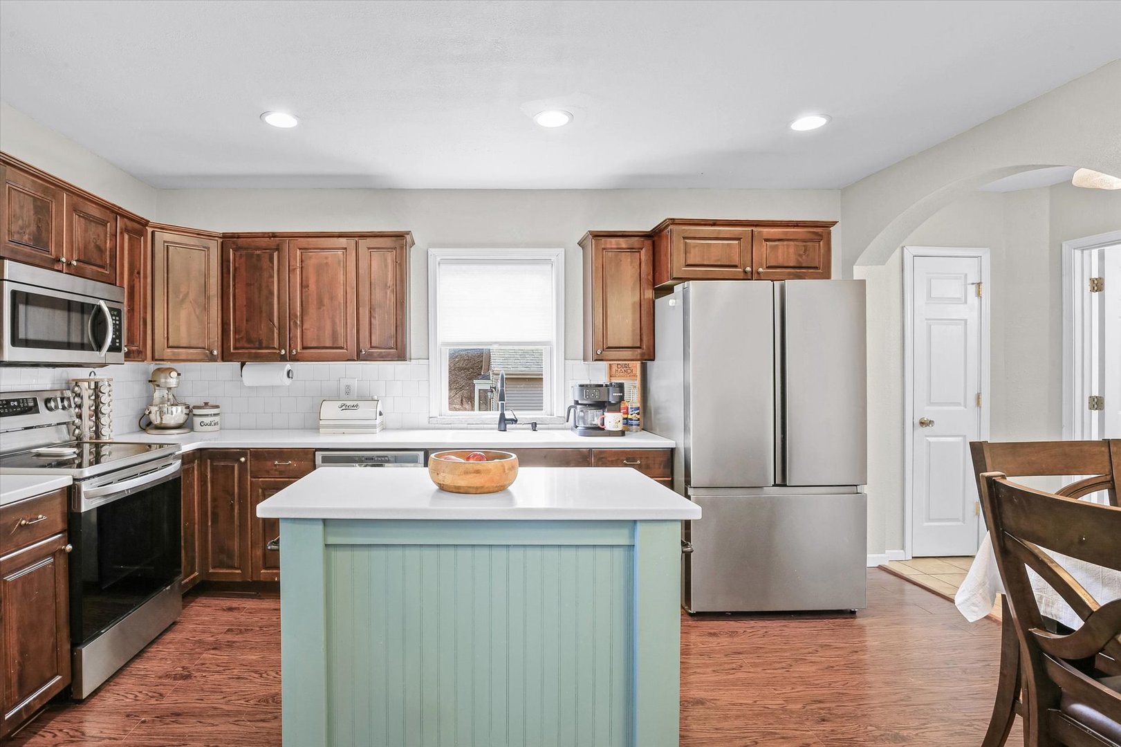 107 Washington Street Congerville, IL 61729 - Photo 12 of 39 a kitchen with a refrigerator a sink a stove a microwave and wooden cabinets