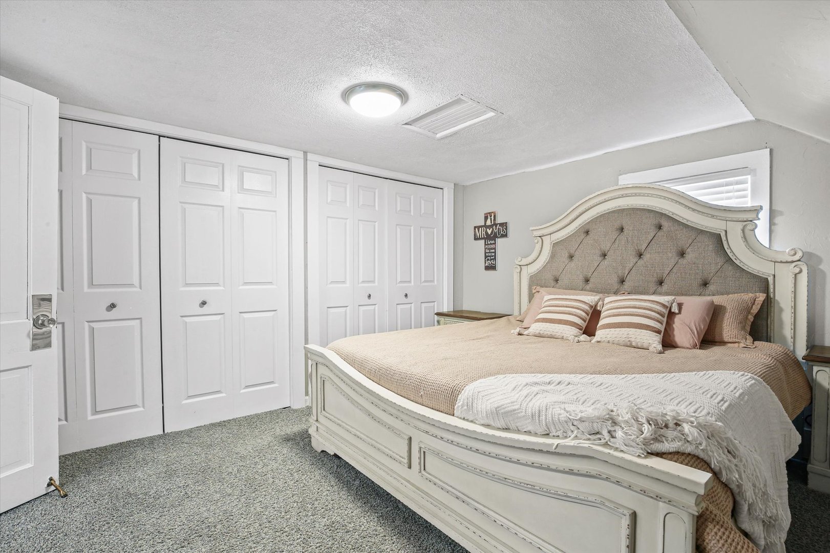 107 Washington Street Congerville, IL 61729 - Photo 26 of 39 a spacious bedroom with a bed and a chandelier