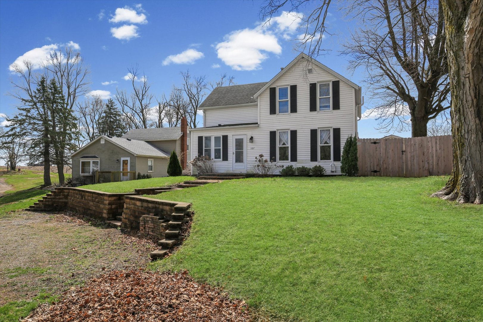 107 Washington Street Congerville, IL 61729 - Photo 4 of 39 a front view of a house with a yard table and chairs