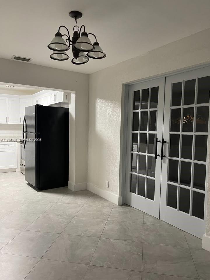 1640 Northeast 33rd Street Pompano Beach, FL 33064 - Photo 5 of 8 a view of empty room with windows and cabinet