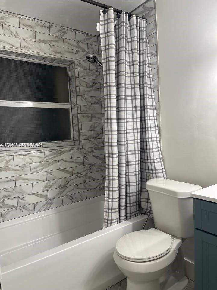 1640 Northeast 33rd Street Pompano Beach, FL 33064 - Photo 6 of 8 a bathroom with a toilet and a shower