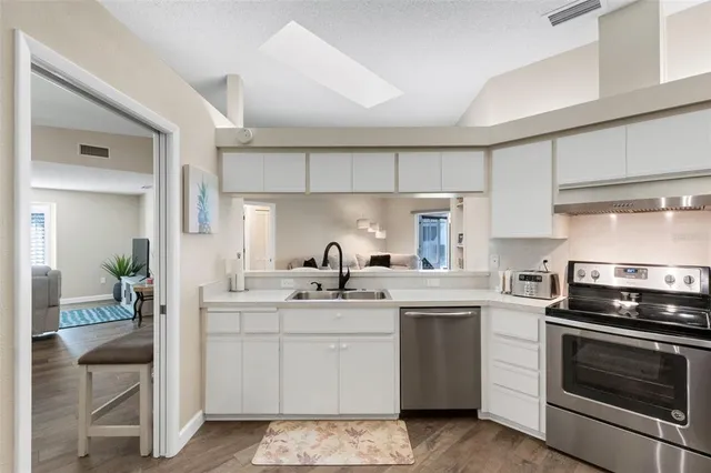a kitchen with a sink stove and cabinets