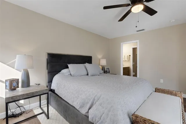 a bedroom with a bed and a chandelier
