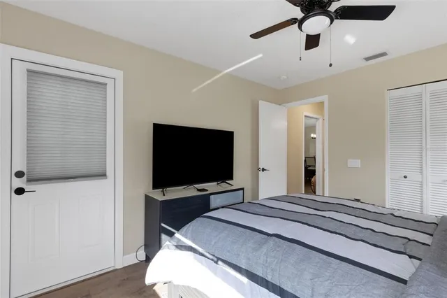 a bedroom with a bed and a flat screen tv