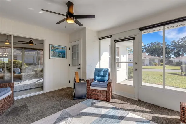 a living room with furniture and a floor to ceiling window