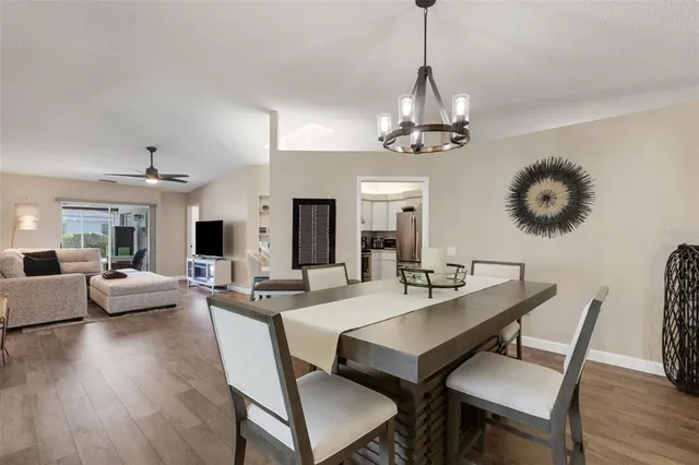 a view of a dining room with furniture wooden floor and chandelier
