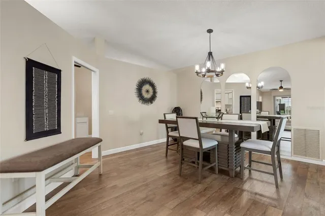a view of a dining room with furniture and chandelier