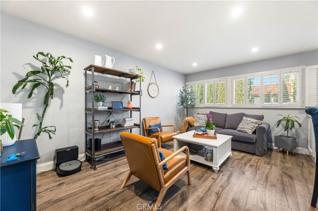 18146 Oxnard Street, Unit 48 Tarzana, CA 91356 - Photo 14 of 52 a living room with furniture and wooden floor