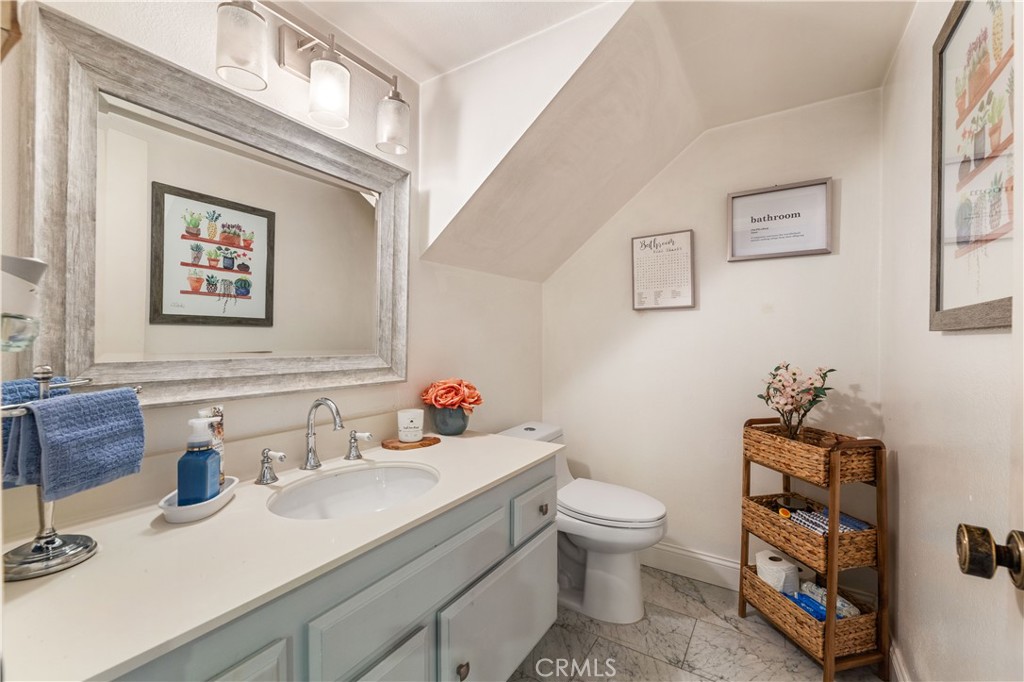 18146 Oxnard Street, Unit 48 Tarzana, CA 91356 - Photo 17 of 52 a bathroom with a sink mirror and toilet