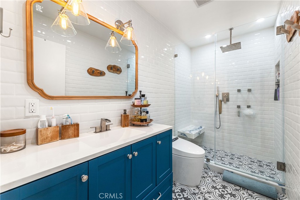 18146 Oxnard Street, Unit 48 Tarzana, CA 91356 - Photo 22 of 52 a bathroom with a sink a toilet and shower