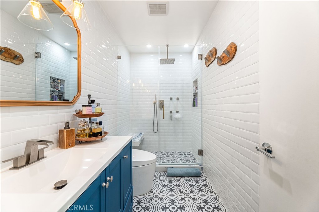 18146 Oxnard Street, Unit 48 Tarzana, CA 91356 - Photo 23 of 52 a bathroom with a sink toilet and shower