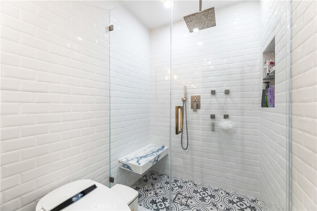 18146 Oxnard Street, Unit 48 Tarzana, CA 91356 - Photo 24 of 52 a bathroom with a toilet and a shower