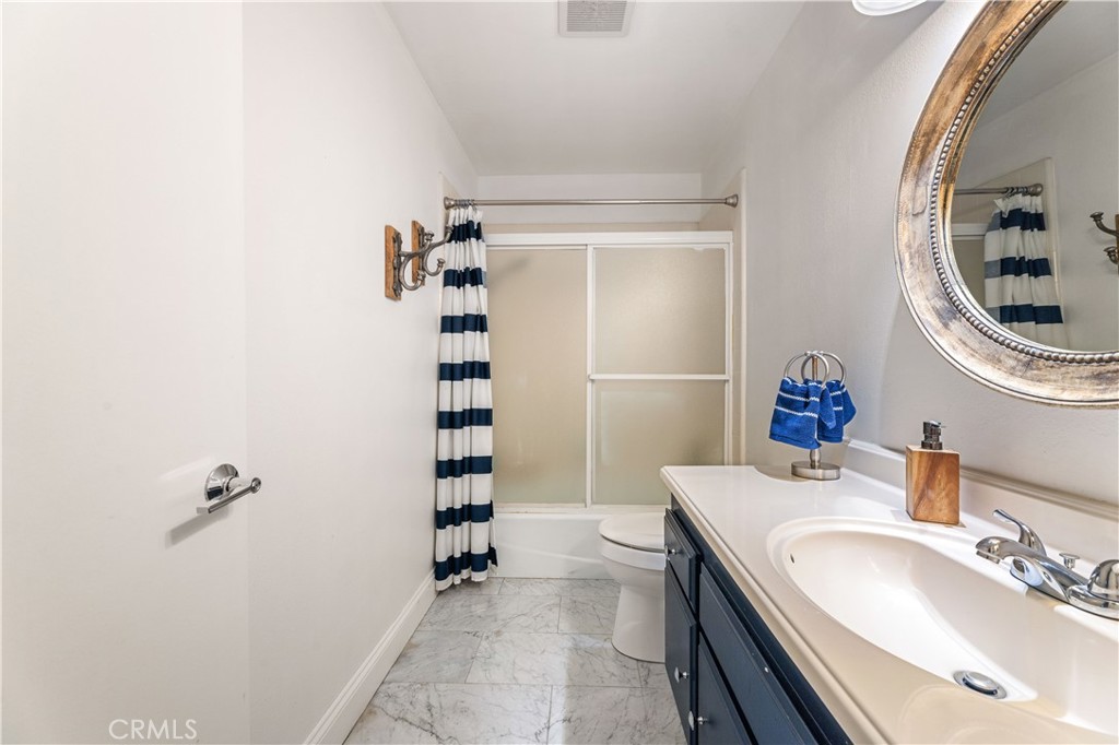 18146 Oxnard Street, Unit 48 Tarzana, CA 91356 - Photo 29 of 52 a bathroom with a sink a toilet and shower