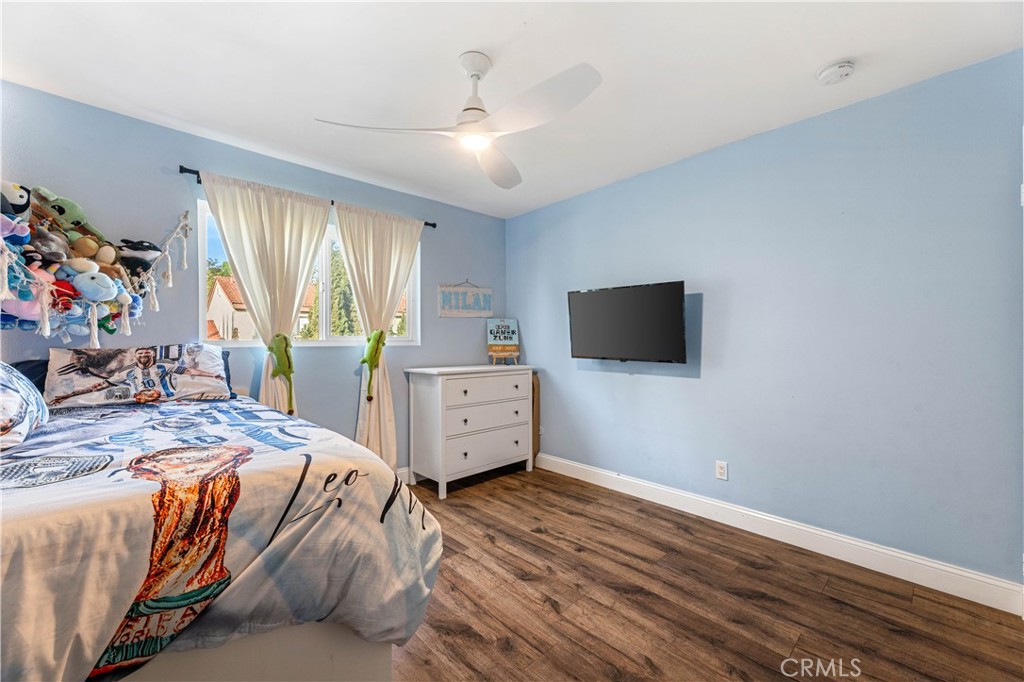 18146 Oxnard Street, Unit 48 Tarzana, CA 91356 - Photo 31 of 52 a room with furniture a flat screen tv and a window